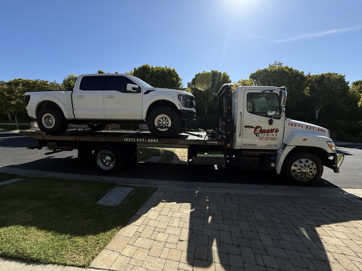 Ford F-150 on flatbed tow truck